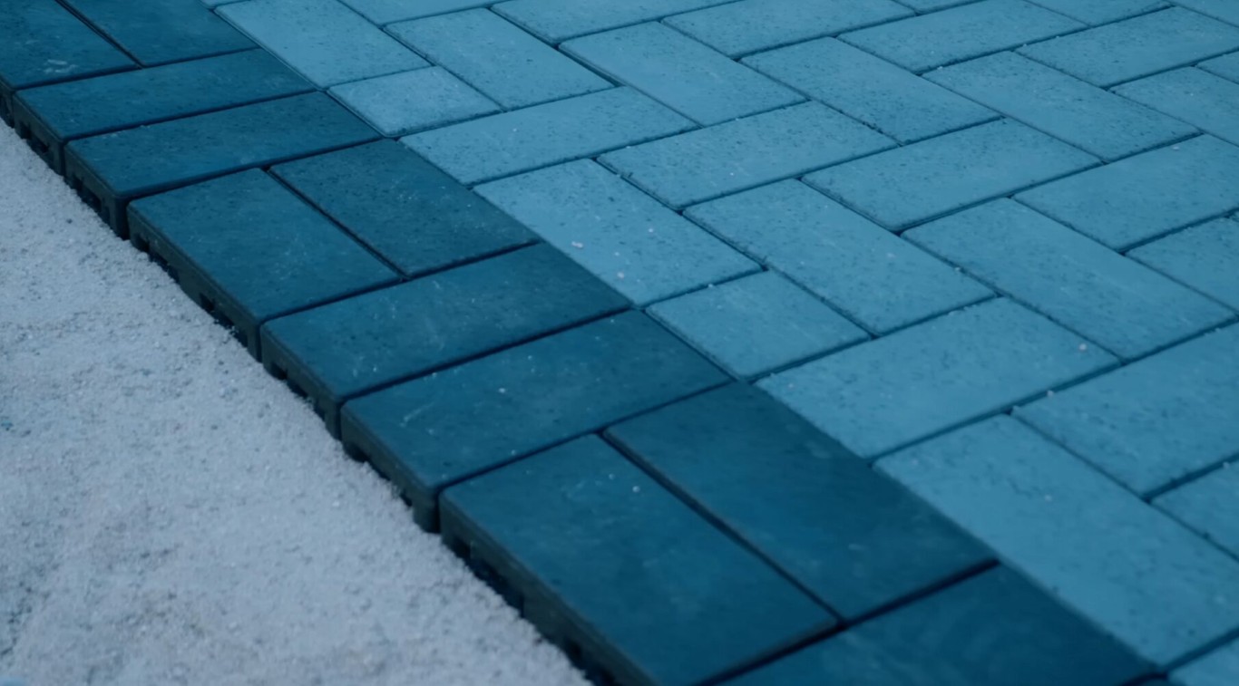 Blue-toned concrete pavers installed in herringbone pattern alongside snow, Sioux Falls SD
